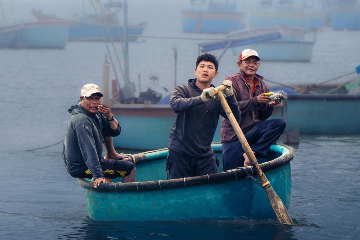 Local people riding traditional Vietnamese coracle boats in Mui Ne